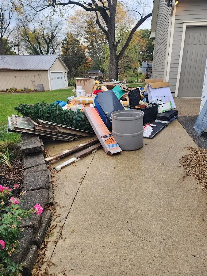 Dumpster being loaded with debris for 12 Yard Dumpster Rental in Breckenridge Hills